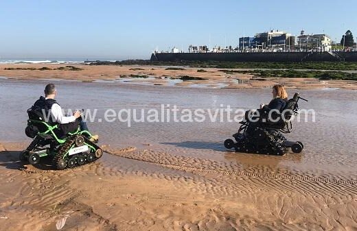 Dos usuarios de silla de ruedas paseando por la playa con las sillas ontrack