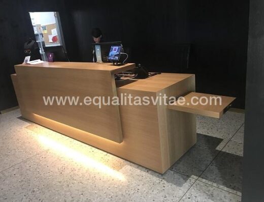 Recepción con espacio adaptado que permite el acercamiento frontal a usuarios en silla de ruedas.