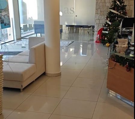 Imagen del interior de las oficinas con el mostrador en la parte derecha y una zona de descanso en la izquierda.
