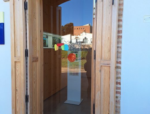 Imagen de la puerta de entrada a la oficina con puerta de cuatro hojas y posterior acristalada.