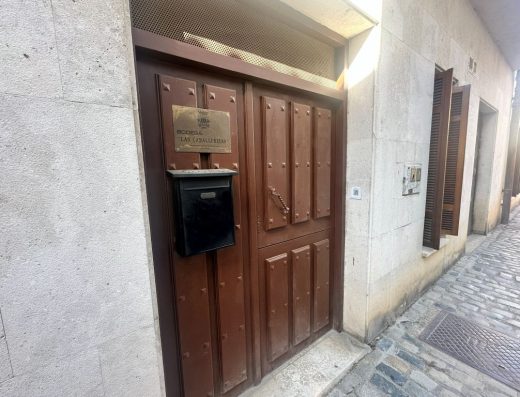 Imagen de la puerta de entrada principal. Puerta de madera con una placa con el nombre.